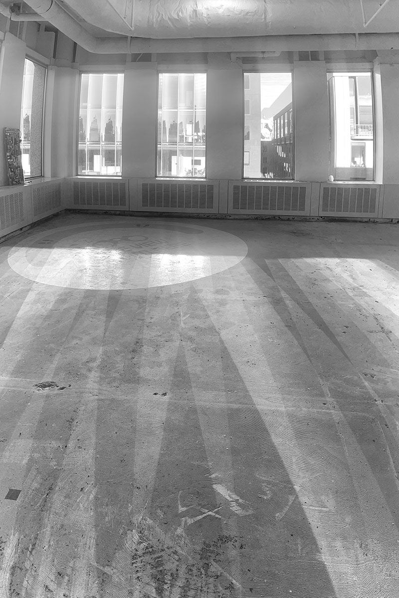 Black and White Photo of Gutted Building Floor with Interesting Radial Shadows.
